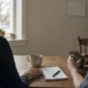 Two mugs and a notepad on a kitchen table where a family talks through hospice vs palliative care